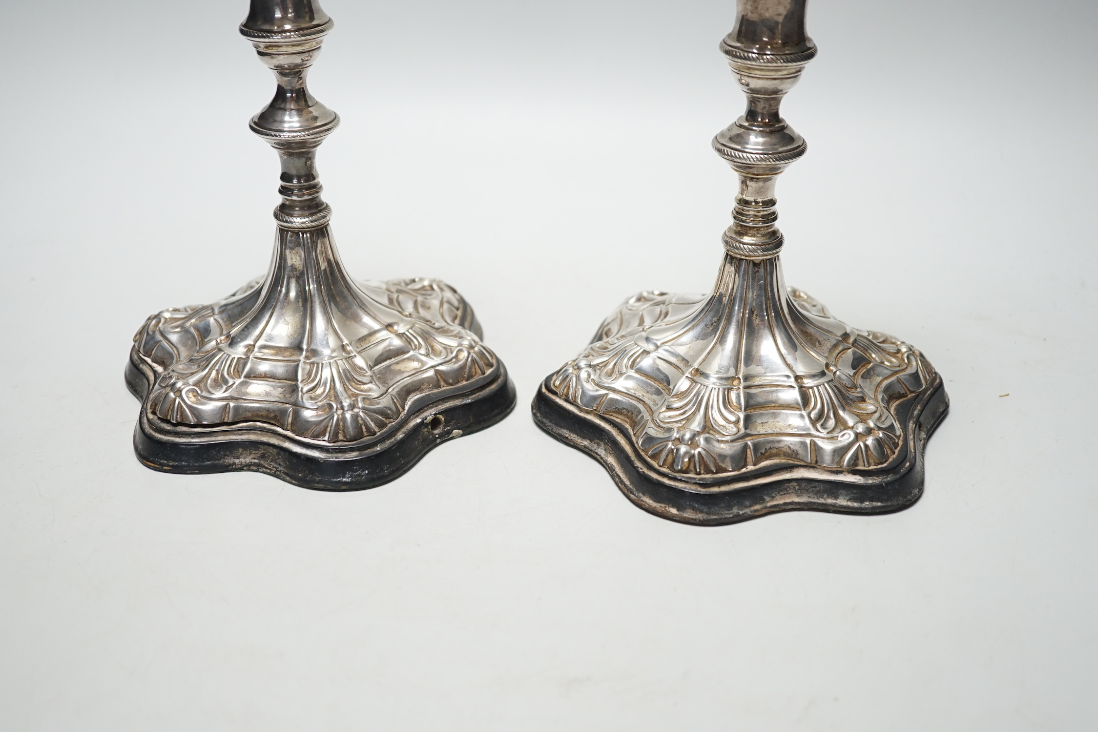 A pair of Georgian? silver candlesticks, on later wooden bases which have been drilled for electricity and later plated? sconces, sticks only, excluding sconces, are 16cm.